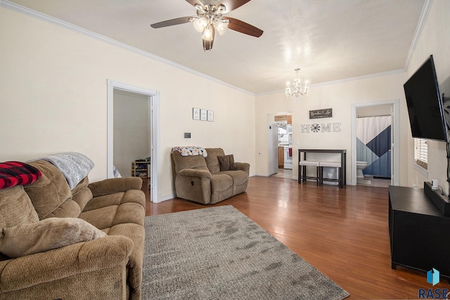 living room featuring ceiling fan with notable chandelier, ornamental molding, and dark hardwood / wood-style floors