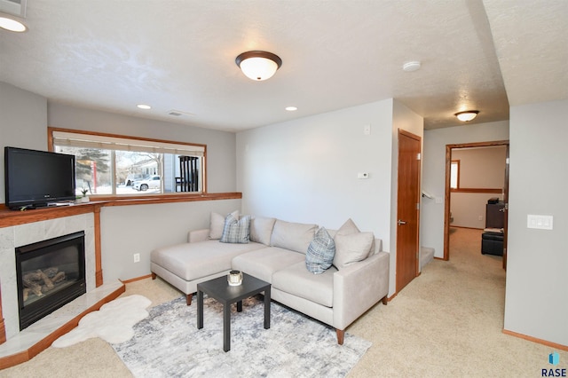 carpeted living room with a tiled fireplace