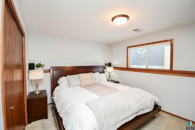 carpeted bedroom with a closet