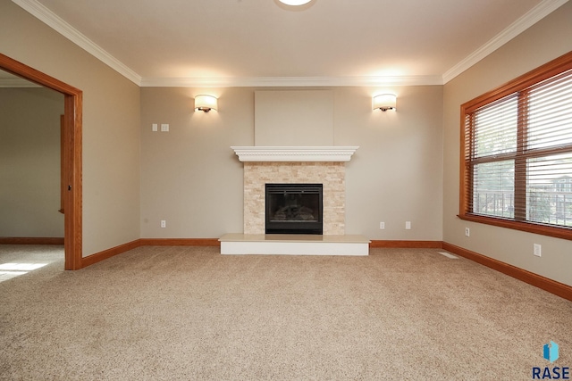 unfurnished living room featuring a stone fireplace, crown molding, and carpet floors