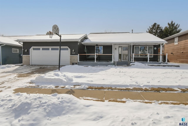 view of front of home featuring covered porch, brick siding, and an attached garage