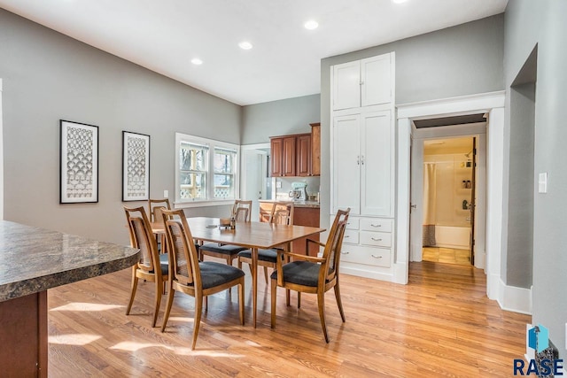 dining room featuring baseboards, recessed lighting, and light wood finished floors