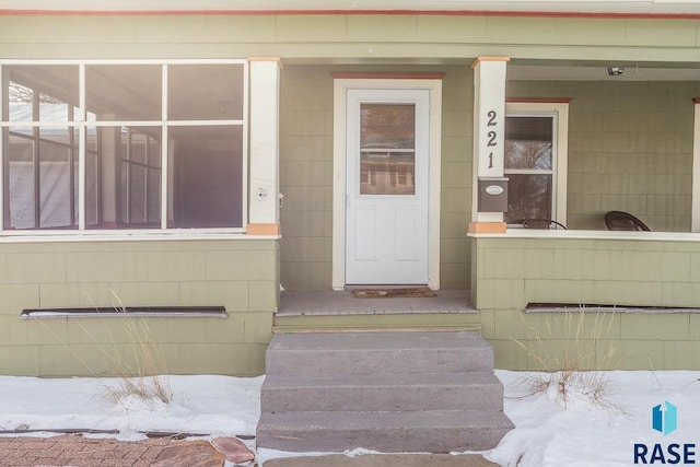 view of snow covered property entrance