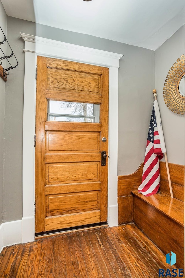 doorway with dark wood-type flooring