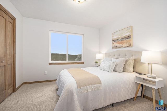 bedroom with light carpet and baseboards