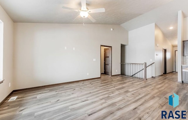 empty room with visible vents, ceiling fan, light wood-style flooring, and baseboards