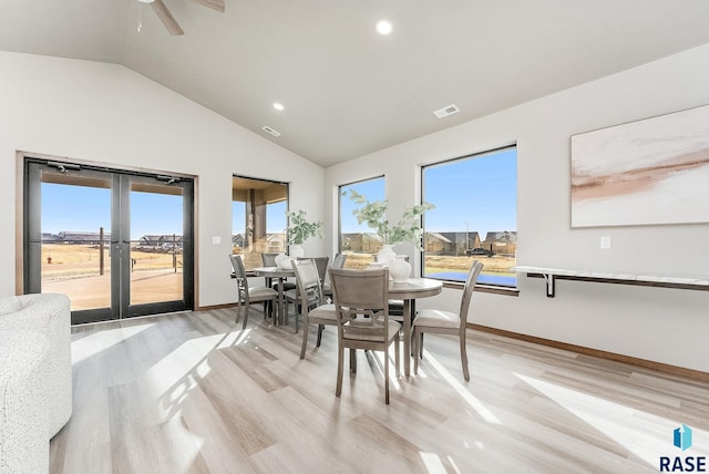 dining area featuring visible vents, baseboards, lofted ceiling, french doors, and light wood-style floors