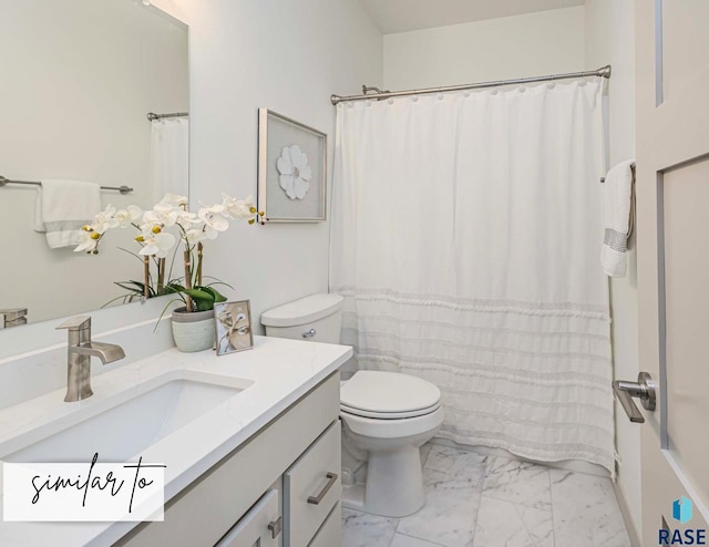 bathroom with toilet, marble finish floor, and vanity