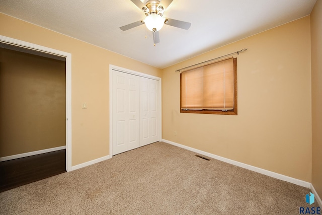 unfurnished bedroom with carpet floors, visible vents, and baseboards