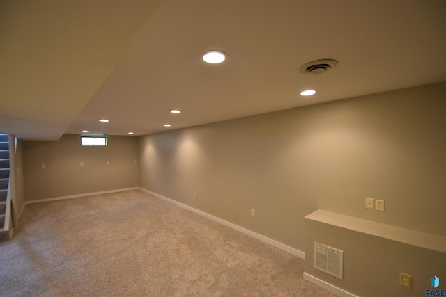 basement with stairs, carpet flooring, and visible vents