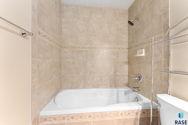 full bath with tiled shower / bath combo and toilet