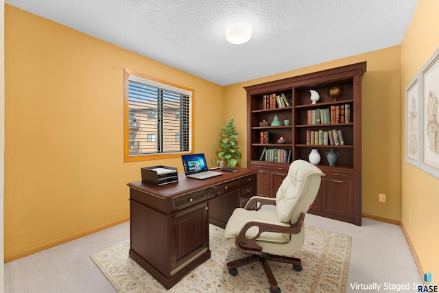 home office with a textured ceiling, light carpet, and baseboards