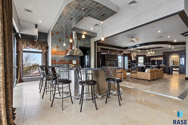 kitchen with arched walkways, visible vents, and a ceiling fan