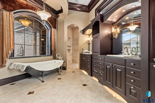 full bathroom featuring vanity, baseboards, a soaking tub, a stall shower, and crown molding