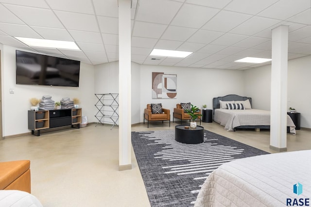 bedroom with baseboards and a drop ceiling