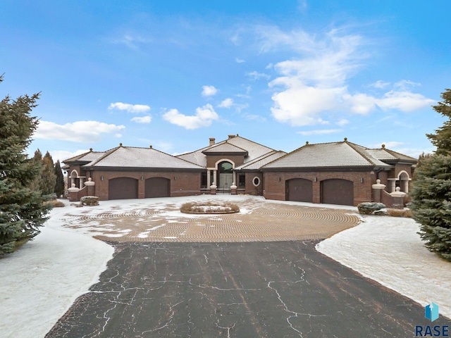 view of front of home with a garage and aphalt driveway