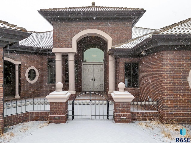 view of snow covered gate