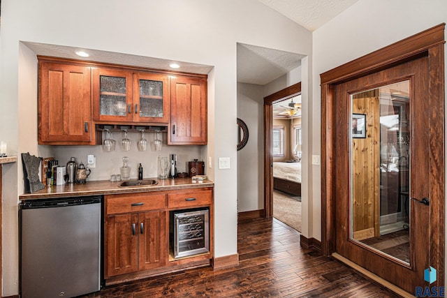 bar featuring dishwashing machine, wine cooler, a sink, vaulted ceiling, and indoor wet bar