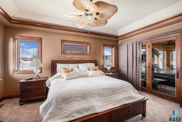 bedroom featuring a raised ceiling, light colored carpet, a textured ceiling, access to outside, and baseboards