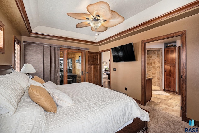 bedroom featuring baseboards, a tray ceiling, a textured ceiling, and carpet flooring