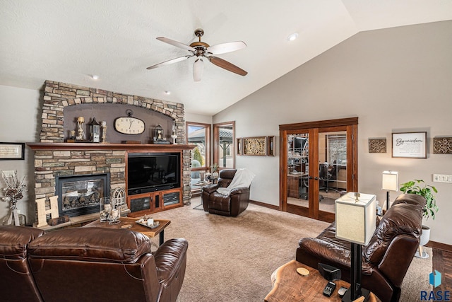 carpeted living room featuring high vaulted ceiling, a fireplace, a ceiling fan, and baseboards