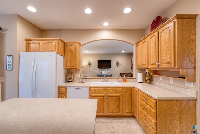 kitchen featuring white appliances, light tile patterned floors, light countertops, a sink, and recessed lighting