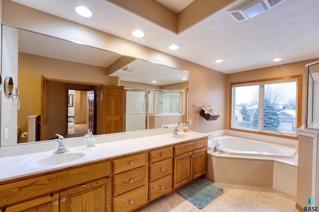 bathroom with double vanity, tile patterned flooring, visible vents, and a sink