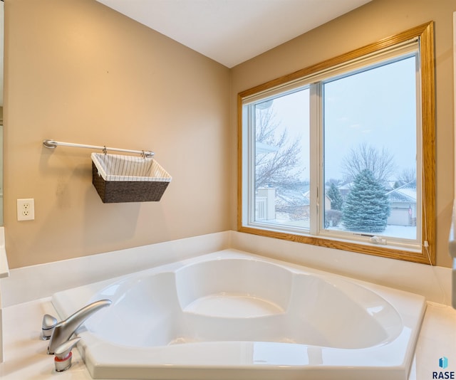 full bathroom with plenty of natural light and a washtub