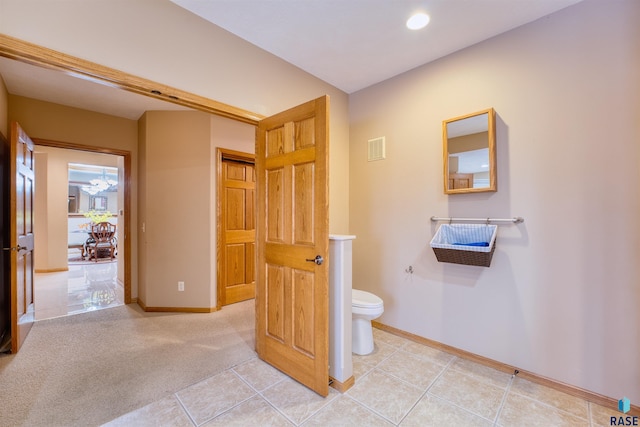 bathroom featuring toilet, tile patterned floors, visible vents, and baseboards