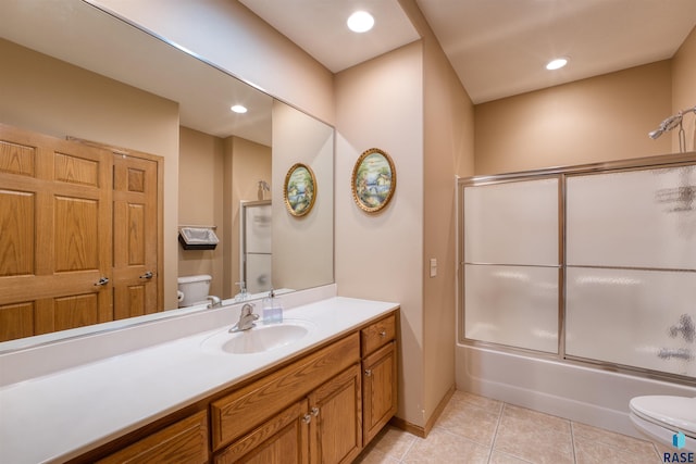 bathroom with bath / shower combo with glass door, toilet, tile patterned floors, vanity, and recessed lighting