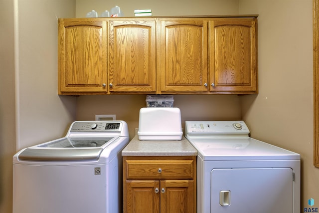 laundry room featuring cabinet space and separate washer and dryer