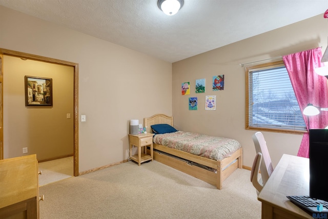 carpeted bedroom with a textured ceiling and baseboards