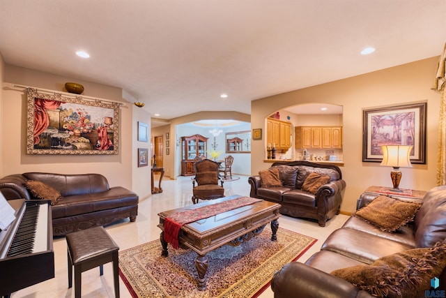 living room featuring arched walkways, a chandelier, and recessed lighting