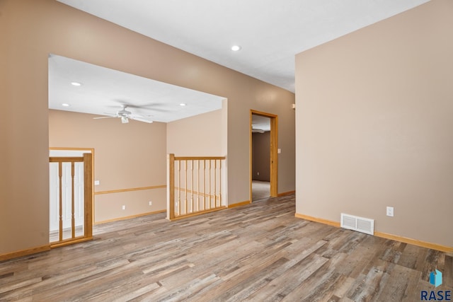 unfurnished room with visible vents, baseboards, light wood-style flooring, ceiling fan, and recessed lighting