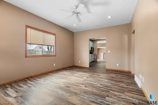 empty room with ceiling fan, dark wood-style flooring, recessed lighting, and baseboards