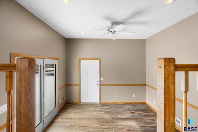 unfurnished room featuring light wood finished floors, ceiling fan, baseboards, and recessed lighting