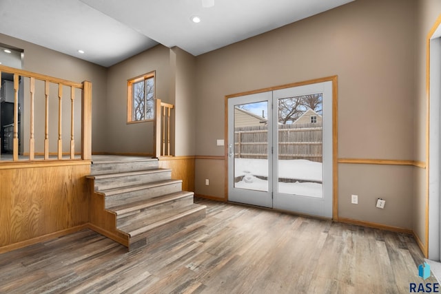 doorway with stairs, recessed lighting, baseboards, and wood finished floors