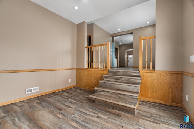 staircase featuring recessed lighting, visible vents, baseboards, and wood finished floors