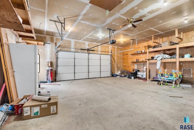 garage featuring a garage door opener and freestanding refrigerator