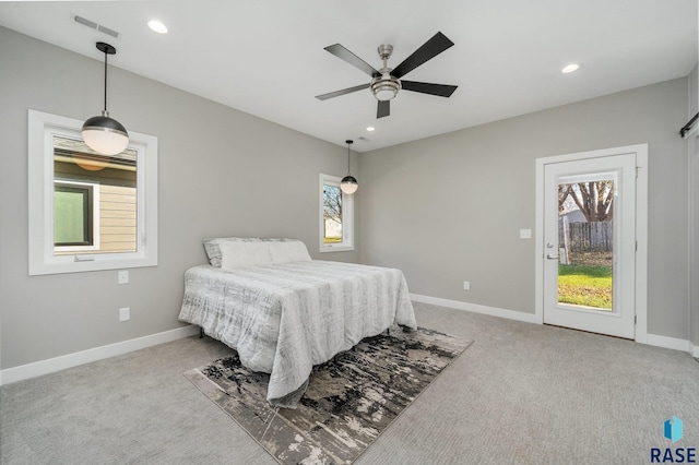 bedroom featuring visible vents, light carpet, and baseboards