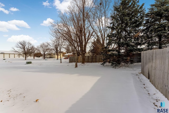 yard layered in snow with fence