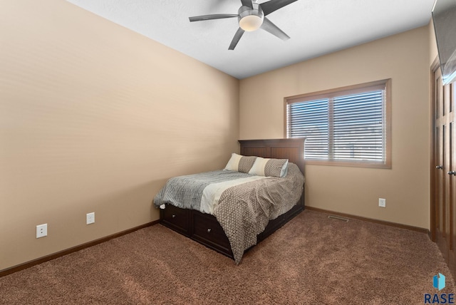 carpeted bedroom with a ceiling fan and baseboards