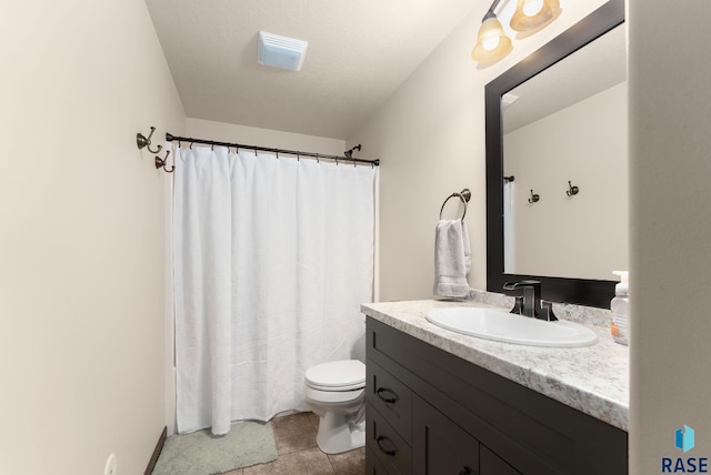 bathroom featuring toilet, curtained shower, and vanity