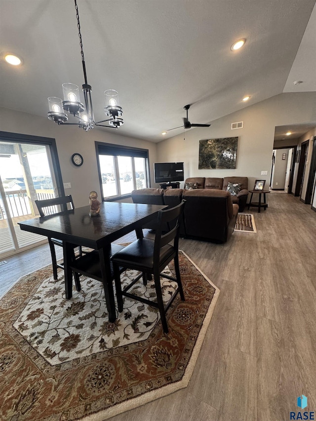 dining area featuring lofted ceiling, wood finished floors, visible vents, and a healthy amount of sunlight