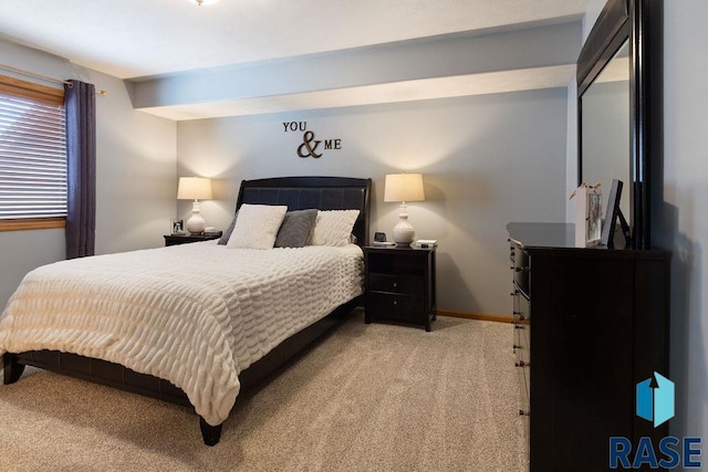 bedroom with baseboards and light colored carpet