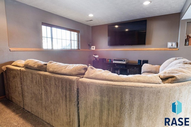 carpeted living area featuring visible vents and recessed lighting