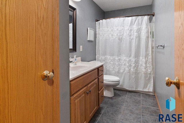 full bath with toilet, tile patterned flooring, and vanity