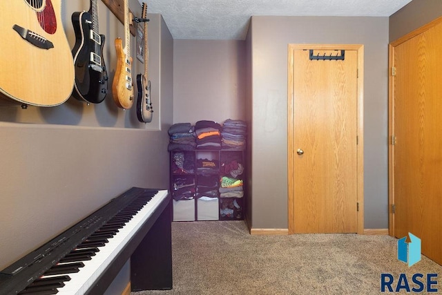 hallway featuring carpet and a textured ceiling