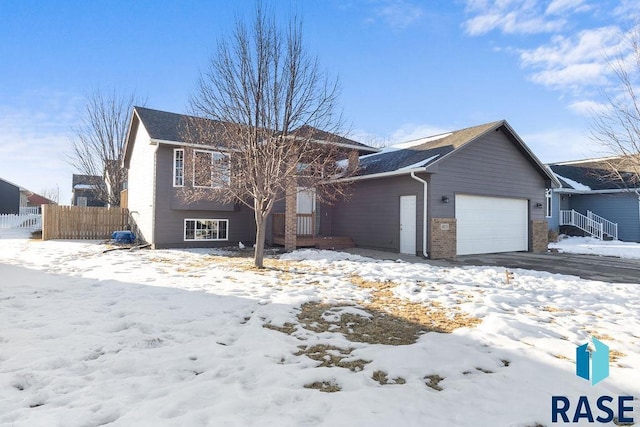 view of front of home with a garage and fence