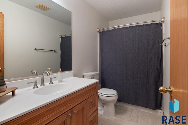 full bath with toilet, vanity, and visible vents